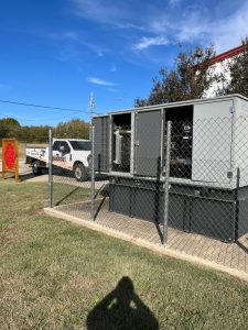 Commercial standby generator with propane tank for reliable emergency backup power.