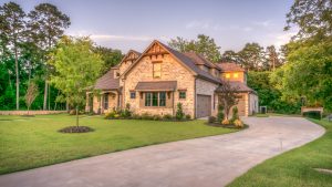 Large single-family home with a landscaped yard, representing residential backup generator installation and home power protection.